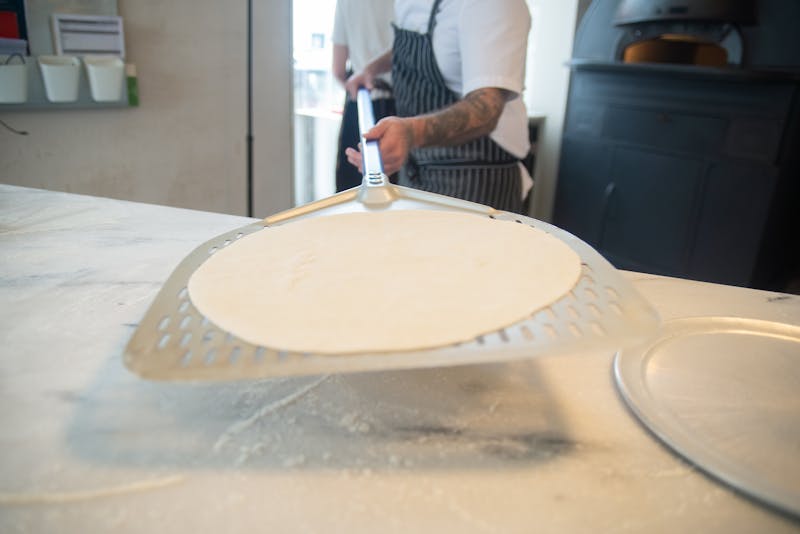 Staff preparing food in a professional kitchen environment